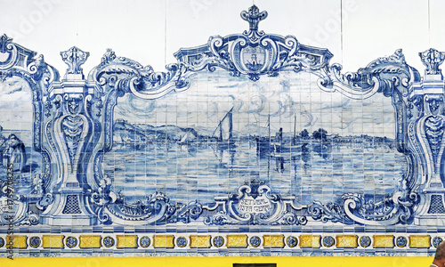 wall mural ceramic tiles, known as azulejos,  with scenes of ships, buildings, and coastal landscapes. The mural includes maritime imagery in Mercado do Livramento in Setubal, Portugal