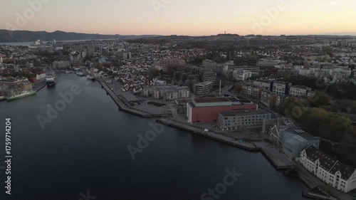 Wallpaper Mural Aerial drone footage capturing downtown Stavanger, Norway at dusk during the fall season. The scene features warm city lights contrasting with the cool autumn tones, showcasing the mix of urban archit Torontodigital.ca
