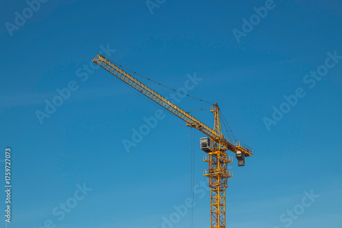 Yellow tower crane against the sky