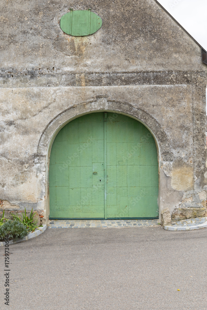 Fototapeta premium Old building archway with green wooden door in Retz, Austria