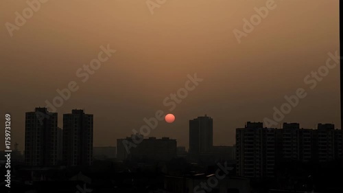 Sunset Over Urban Skyline with Silhouettes of Tall Buildings