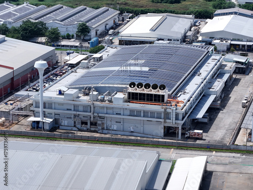 Cooling towers in data center building. Air conditioning cooling towers in front of building with fins to the front. Industrial cooling towers or air cooled water chillers with piping system.