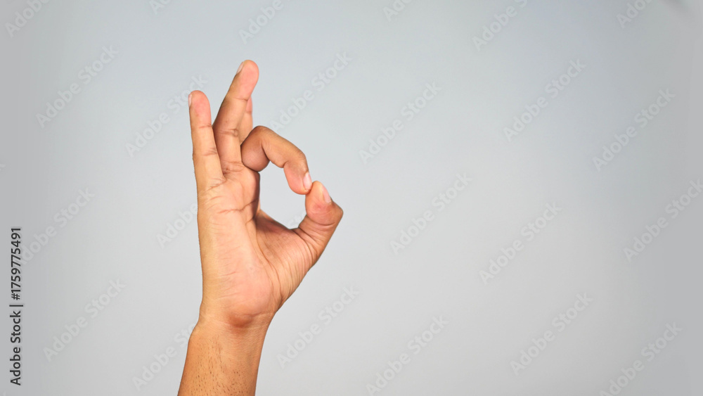 Naklejka premium Hand Gesture Showing Quality Sign — OK Symbol Close-Up on Studio Background