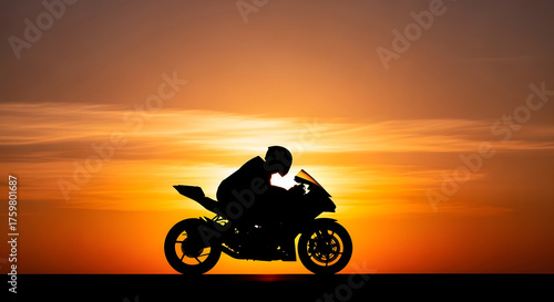 Silhouette of a motorcycle rider against a vibrant sunset sky with clouds and orange colors