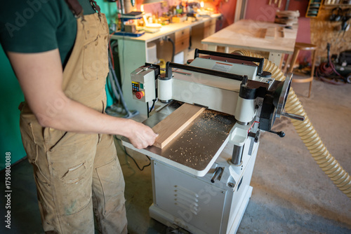 Cuadro en lienzo Carpenter shaping wooden block on planer thicknesser jointer machine in workshop