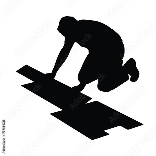 Silhouette of a person laying flooring or tiling on the floor