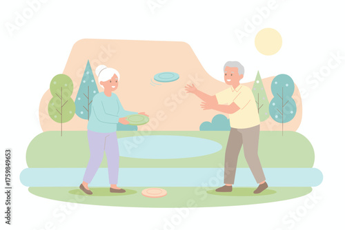 Happy senior couple playing frisbee in a park enjoying an active healthy retirement lifestyle