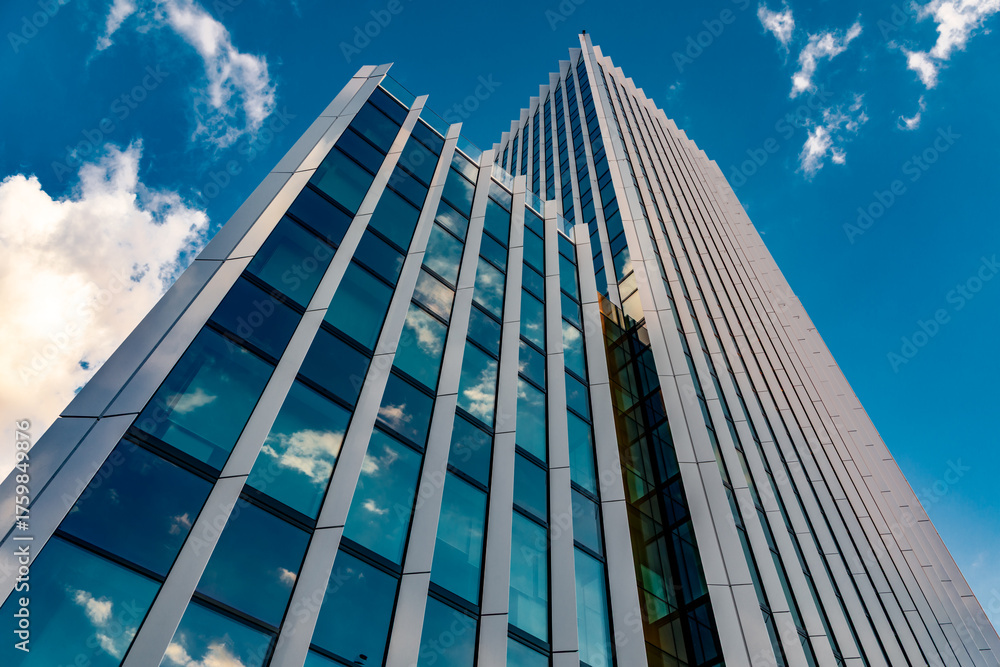 Obraz premium Modern Skyscraper Facade Looking Up at Blue Sky