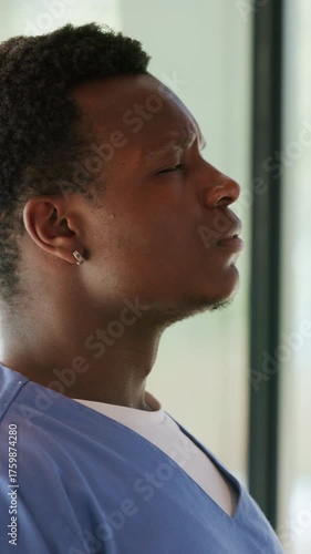 Wallpaper Mural Black man, thinking and tired nurse with stress, breathing or overwhelmed by window. Healthcare worker, fatigue or person in hospital with difficult surgery, medical burnout or reflection for mistake Torontodigital.ca