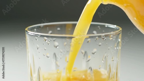 pouring orange juice into glass