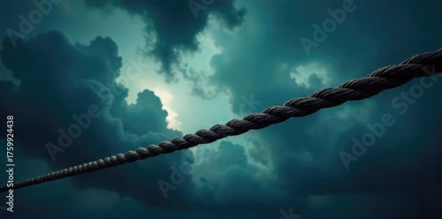 A taut rope stretches across a dramatic, stormy sky, creating a sense of suspense and unease The dark clouds and ominous lighting add to the feeling of tension , lighting, pressure