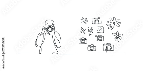 Person holding camera with collection of cameras and nature elements