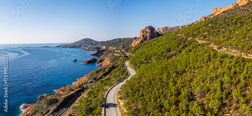 Aerial view of Esterel Mountains and winding coastal road above the blue Mediterranean Sea, French Riviera, France