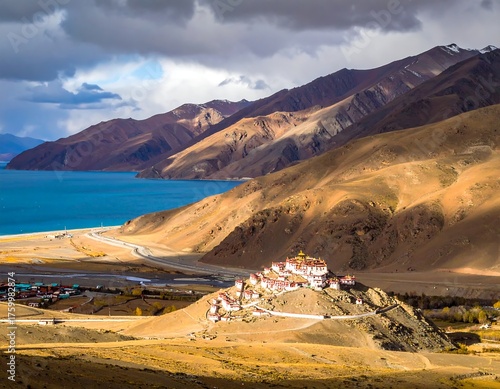 Scenic landscape with a lake, mountains, and a hilltop monastery