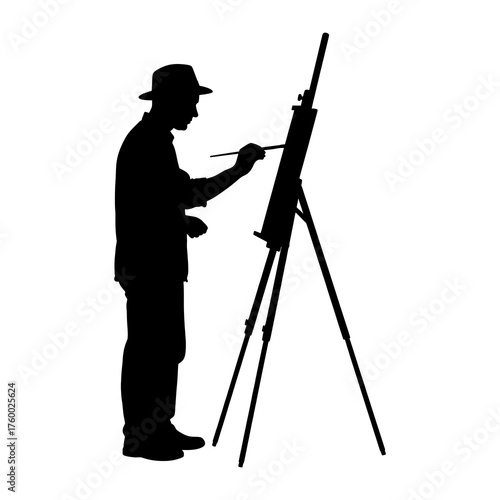 Silhouette of a caucasian male artist painting on easel in profile view