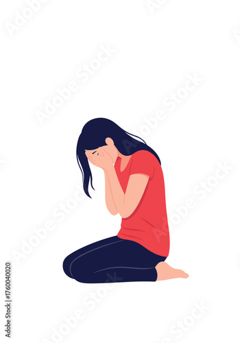 A person kneels on the floor covering their face with their hands in despair.