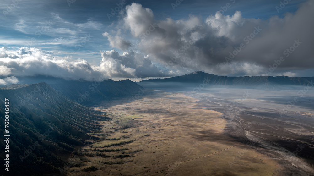 Obraz premium Aerial View of Indonesia's Volcanic Terrain: Sweeping Valley and Dramatic Clouds in a Picturesque Mountain Landscape for Scenic Nature Photography