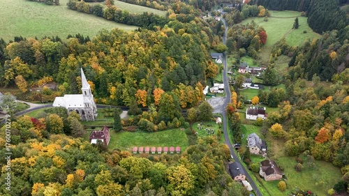 Aerial mountain valley village Travna Czechia autumn pull 3. Czech Republic, Czechia historically known as Bohemia. Central Europe. Autumn fall season. Farm rural area landscape. Mountain valley.