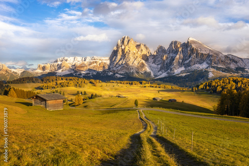 Beautiful view of mountain range on scenic Alpe di Siusi in golden light at sunset, Dolomites, South Tyrol, Italy. Horizontal photo.