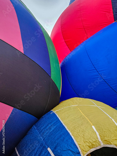 Colorful closeup of the bright and vibrant fabric of three different hot air balloons.