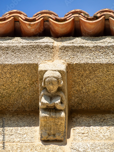 Stone carved figure holding a book, Collegiate church of Santa María la Real de Sar, Santiago de Compostela