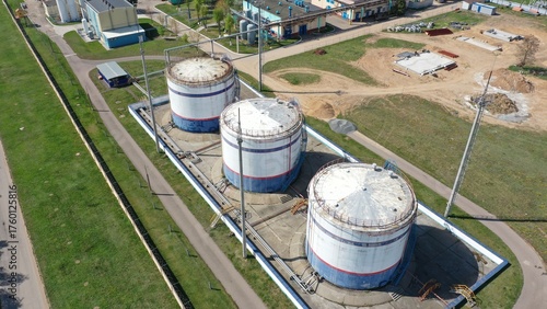 Open-air oil storage tanks at a refinery. Russian oil refinery. Oil storage in huge tanks.