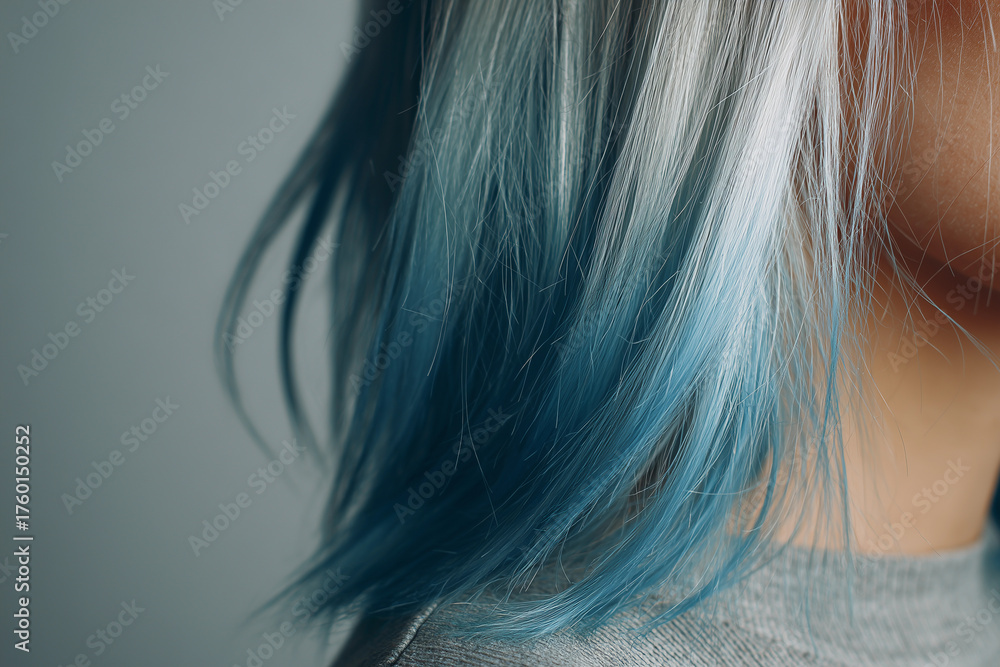 Naklejka premium Transforming hair with a stunning gradient from silver to vibrant blue in a simple studio setting