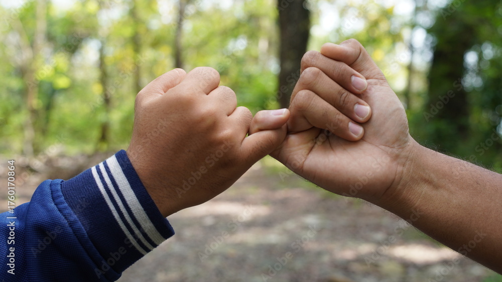Φωτογραφία Two people link their pinky fingers in a symbolic gesture of a pinky promise or