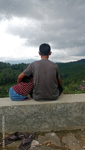 young man sitting on a stone