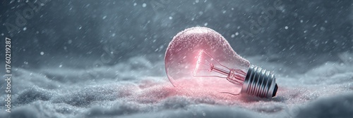 A light bulb rests on a blanket of snow, glowing with a gentle pink light while snowflakes fall around it, creating a serene winter scene.