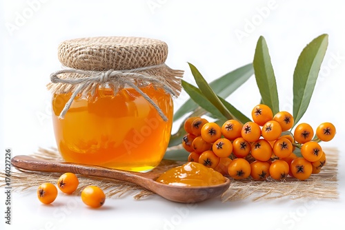 Jar of golden sea buckthorn jam with berries and leaves isolated on white background