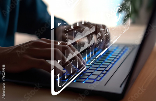Hands Using Laptop with Futuristic Graphs and Data Representations on Screen for Technology and Business Analysis