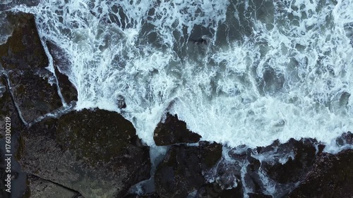 Close-up Aerial View of Waves Breaking Against Rocky Shore, Majestic Nature Background