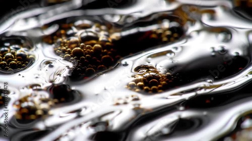 Wallpaper Mural Close-up abstract macro view of dark liquid with numerous small bubbles and reflective surface creating a dynamic and intriguing texture, perfect for background or experimental visuals. Torontodigital.ca