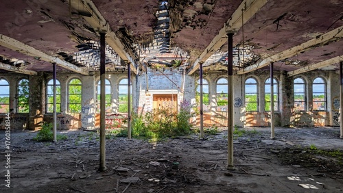 Derelict disused factory collapsing, Wigan 03.05.25 Abandoned old industrial warehouse, peeling paint, bright sunlight through broken windows. Post-apocalyptic decaying building. Crumbling ruins