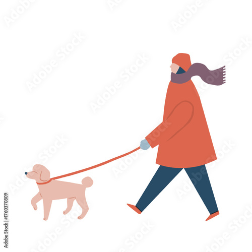 犬の散歩をする冬服を着た女性