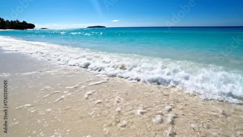 Tranquil Beach Scene with Footprints in the Soft Sand and Waves