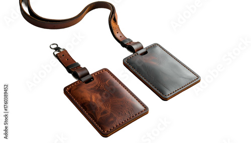 Two leather luggage tags connected by a strap on black backdrop