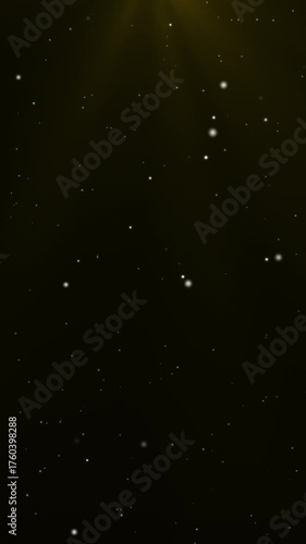 Vertical background video with sparkling light particles shining in gold light