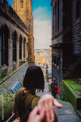 Couple traveling in Edinburgh, Scotland. Traveling together. Follow me.