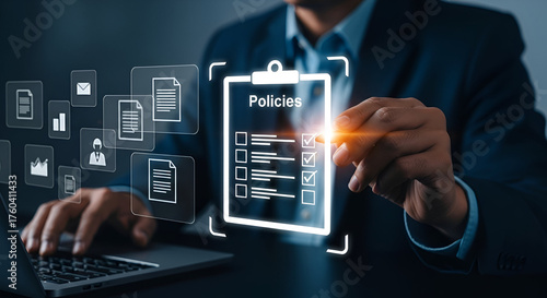Businessman reviewing policies on a digital clipboard with icons
