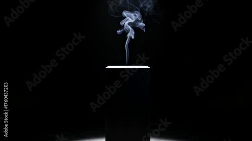 Thin stream of smoke rising from a black pedestal illuminated by a single spotlight in a dark minimalist room