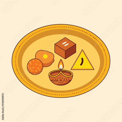A traditional Indian offering plate with a lit diya lamp and assorted sweets for a festival celebration.