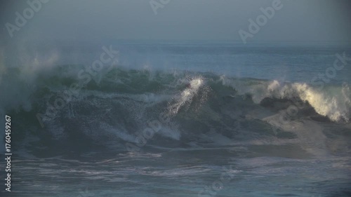 Bodyboarder kicking out of large storm waves
