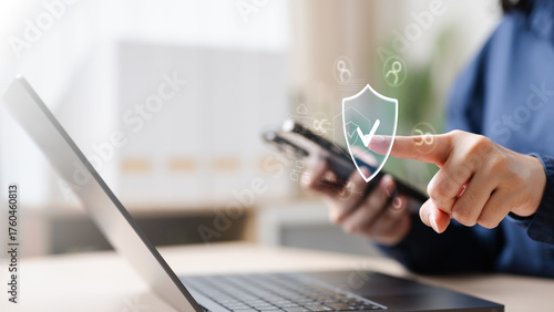 Billede på lærred screen, share, prompt, permission, window, app, A person using a laptop and smartphone with a digital shield icon, representing secure screen sharing, data protection, and privacy permission control