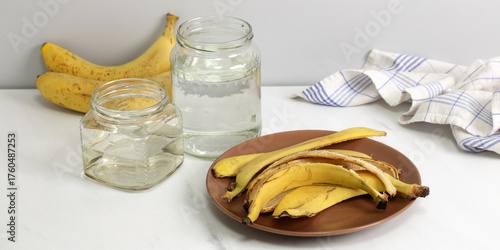 Banana peel fertilizer making with water jars on counter