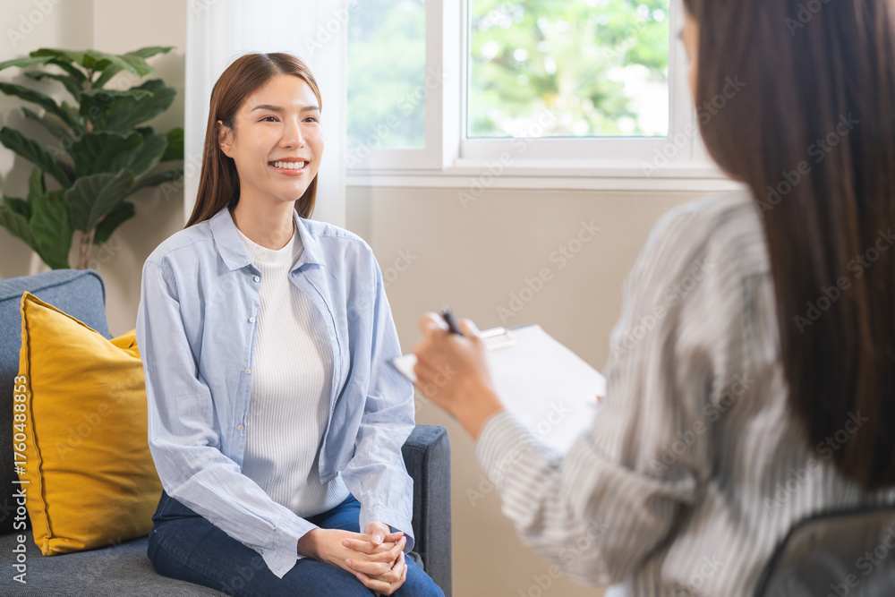 Obraz premium Psychology, depression. Suffer asian young woman consultation with psychologist while patient counseling mental therapy, doctor hand taking notes at clinic. Psychologist with sick mental health person