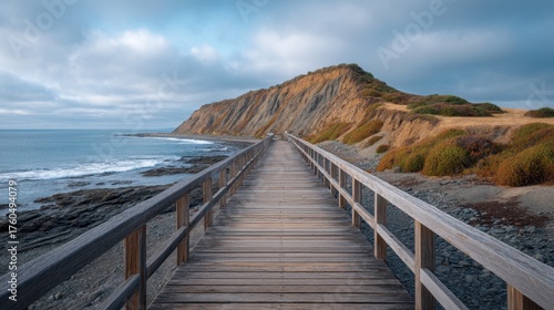 Wallpaper Mural Tranquil Morning Light Illuminates Wooden Boardwalk Leading to Coastal Cliffs and Peaceful Waters in Dramatic Natural Landscape Torontodigital.ca