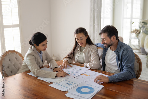 Concentrated family couple listen to financial review from trusted specialist