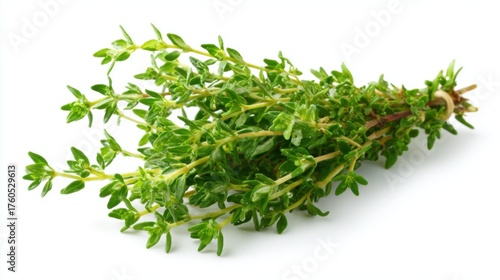 A bundle of fresh thyme rests on a white surface showcasing its lively green leaves. This herb is often used in cooking for its aromatic flavor and health benefits.